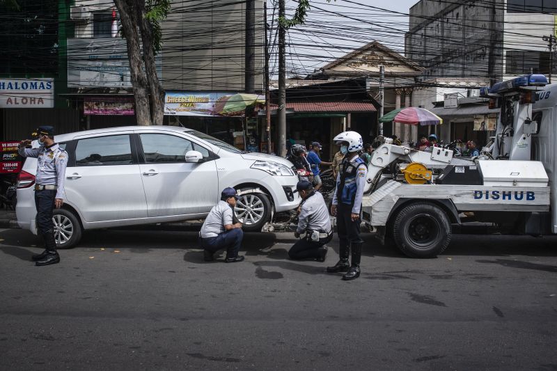 Petugas Dinas Perhubungan DKI Jakarta menderek mobil yang parkir sembarangan di Jalan Raya Mangga Besar, Jakarta, Senin (12/11). Antara Foto.