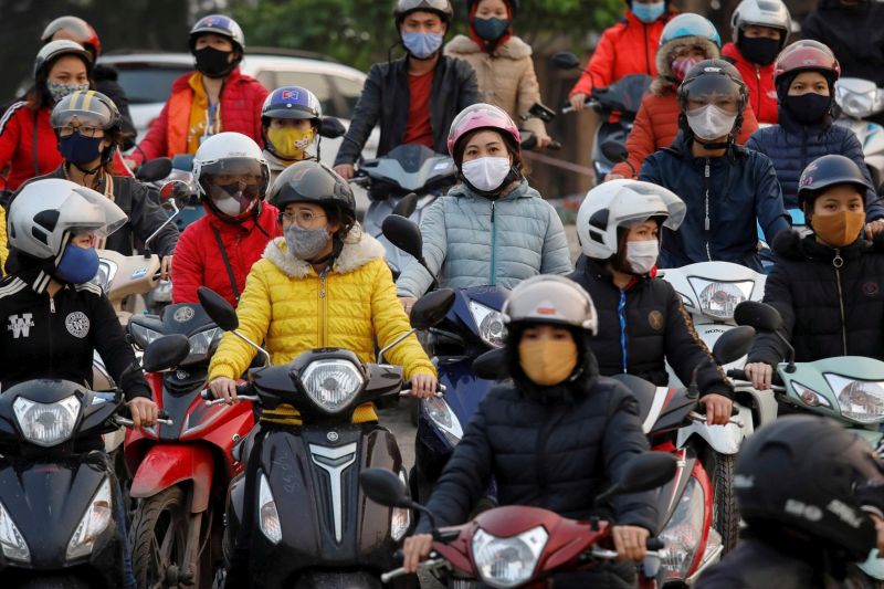Para buruh memakai masker pelindung berkumpul saat mereka menunggu kapal feri untuk pulang setelah bekerja, meski ada peraturan pemerintah mengenai social distancing (pembatasan sosial) saat penyebaran penyakit virus korona (COVID-19) di provinsi Hai Duong, Vietnam, Selasa (7/4/2020). Foto Antara/Reuters/Kham.