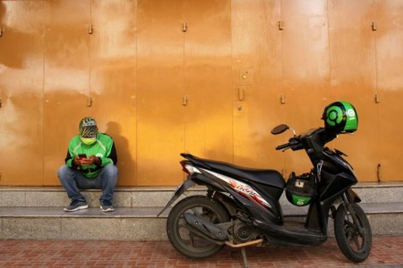 Pengemudi ojek daring menunggu pesanan di Makassar, Sulawesi Selatan, Sabtu (4/4). /Foto Antara